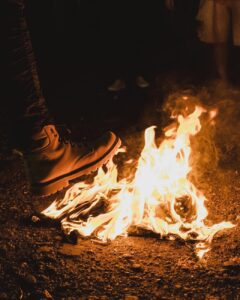 photo of a person s foot near flames